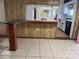 Dining room with faux wood paneling, tile floors, and a window at 2105 E Cherokee St, Bartow, FL 33830