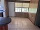 Dining room with tile flooring, wood paneling, and a large window at 2105 E Cherokee St, Bartow, FL 33830