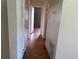 Hallway with tiled floor leading to rooms with neutral walls at 2105 E Cherokee St, Bartow, FL 33830