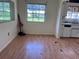 A worn kitchen featuring white cabinets and damaged flooring at 2105 E Cherokee St, Bartow, FL 33830