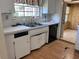 Kitchen featuring wood paneling, tile floors, and a breakfast bar at 2105 E Cherokee St, Bartow, FL 33830