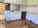A damaged kitchen showing the sink and a built-in dishwasher at 2105 E Cherokee St, Bartow, FL 33830