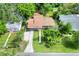Aerial view of a single-story home with a long driveway and lush green landscaping at 215 W Valencia St, Lakeland, FL 33805