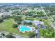 This aerial showcases community amenities including a large pool, tennis courts and a gymnasium nearby at 215 W Valencia St, Lakeland, FL 33805