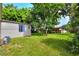Lush backyard with mature trees, showcasing the home's outdoor space and landscaping at 215 W Valencia St, Lakeland, FL 33805