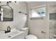 Updated bathroom features new vanity, toilet, faucet, mirror, fixtures, and tiled shower at 215 W Valencia St, Lakeland, FL 33805