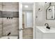 View of updated bathroom featuring new vanity, toilet, mirror, fixtures, and tiled shower at 215 W Valencia St, Lakeland, FL 33805