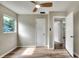 Roomy bedroom with new wood-look vinyl flooring, ceiling fan, and a jalousie window at 215 W Valencia St, Lakeland, FL 33805