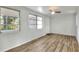 Spacious bedroom with hardwood floors and abundant natural light from two large windows at 215 W Valencia St, Lakeland, FL 33805