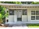 View of covered back porch and door featuring a security gate at 215 W Valencia St, Lakeland, FL 33805