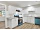 Bright kitchen featuring white cabinets, stainless steel appliances, and stylish countertops at 215 W Valencia St, Lakeland, FL 33805