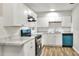 A clean kitchen features white cabinets, updated appliances, and modern countertops at 215 W Valencia St, Lakeland, FL 33805
