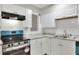 This kitchen features white cabinets, stainless steel appliances, and stylish countertops at 215 W Valencia St, Lakeland, FL 33805