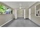 Bright laundry area featuring gray flooring and a utility sink tucked away behind double doors at 215 W Valencia St, Lakeland, FL 33805