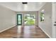 Bright living room featuring hardwood floors, a large window, and a decorative front door at 215 W Valencia St, Lakeland, FL 33805