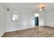 A modern living room is freshly painted, has an overhead ceiling fan, and laminate flooring at 215 W Valencia St, Lakeland, FL 33805