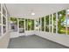 A large screened porch with views of mature landscaping offers plenty of natural light at 215 W Valencia St, Lakeland, FL 33805