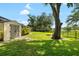 Well-maintained backyard with storage shed, mature trees and fire pit at 2208 Deerbrook Dr, Lakeland, FL 33811