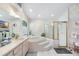 Spacious bathroom with floral wallpaper, walk-in shower, soaking tub and a double sink vanity at 2208 Deerbrook Dr, Lakeland, FL 33811
