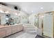 Bright bathroom features a sunken tub with tile surround and glass enclosed shower at 2208 Deerbrook Dr, Lakeland, FL 33811