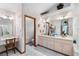 Bathroom featuring double vanity and makeup vanity, adorned with floral wallpaper at 2208 Deerbrook Dr, Lakeland, FL 33811
