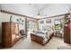 Cozy bedroom with carpet, ceiling fan, closet, and large glass doors leading to the backyard at 2208 Deerbrook Dr, Lakeland, FL 33811