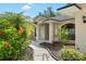 Close-up view of home's entrance with landscaped walkway and decorative plants, adding a touch of elegance at 2208 Deerbrook Dr, Lakeland, FL 33811