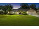 Charming single-story home with lush lawn, mature trees and inviting front entrance and attached two car garage at 2208 Deerbrook Dr, Lakeland, FL 33811