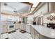 Well-lit kitchen featuring white appliances, plenty of counter space, and a view to the adjacent breakfast nook at 2208 Deerbrook Dr, Lakeland, FL 33811