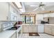 Well-lit kitchen with bright cabinets, modern appliances, and a view of the backyard through the window at 2208 Deerbrook Dr, Lakeland, FL 33811