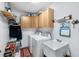 Efficient laundry room features cabinetry and utility sink at 2208 Deerbrook Dr, Lakeland, FL 33811