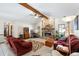 Inviting living room featuring a stone fireplace, ceiling fan, and comfortable seating for relaxation and entertainment at 2208 Deerbrook Dr, Lakeland, FL 33811