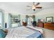 Bright main bedroom featuring light walls, a ceiling fan, and access to the patio at 2208 Deerbrook Dr, Lakeland, FL 33811