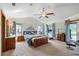 Spacious main bedroom with large windows, a ceiling fan and access to the patio and backyard at 2208 Deerbrook Dr, Lakeland, FL 33811