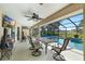 Covered lanai with table and swivel chairs and view to pool at 2208 Deerbrook Dr, Lakeland, FL 33811
