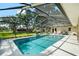 Beautifully landscaped pool area with screened enclosure and large yard at 2208 Deerbrook Dr, Lakeland, FL 33811