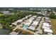 An aerial view shows a neighborhood of lakeside condos with a pool and private dock at 2219 Starboard Rd, Winter Haven, FL 33881