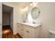 Bright bathroom featuring a double vanity with modern fixtures and an adjacent toilet at 2219 Starboard Rd, Winter Haven, FL 33881
