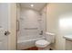 Clean bathroom with a bathtub, shower, toilet and grab bars for accessibility at 2219 Starboard Rd, Winter Haven, FL 33881