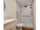 Accessible shower showcasing marble-style tiles, glass shelves, and a handheld sprayer at 2219 Starboard Rd, Winter Haven, FL 33881