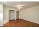 Empty bedroom with hardwood floors, ceiling fan, and closet with double doors at 2219 Starboard Rd, Winter Haven, FL 33881