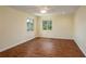 A bright bedroom features wood floors, a ceiling fan, and windows offering natural light at 2219 Starboard Rd, Winter Haven, FL 33881