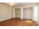 Spacious bedroom with a ceiling fan, hardwood floors, and an open closet at 2219 Starboard Rd, Winter Haven, FL 33881