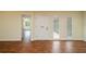 Bright entryway featuring hardwood floors, white trim, and a contemporary white front door with sidelights at 2219 Starboard Rd, Winter Haven, FL 33881