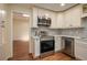 Updated kitchen with stainless steel appliances, white cabinets, tile backsplash and wood floor with recessed lights at 2219 Starboard Rd, Winter Haven, FL 33881