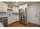 Modern kitchen featuring white cabinets, stainless appliances, mosaic backsplash and wood flooring at 2219 Starboard Rd, Winter Haven, FL 33881