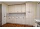 Well-lit kitchen featuring stylish cabinets, mosaic backsplash, and stainless-steel appliances at 2219 Starboard Rd, Winter Haven, FL 33881