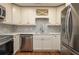Modern kitchen with white cabinets, mosaic backsplash, stainless steel appliances, and white countertops at 2219 Starboard Rd, Winter Haven, FL 33881