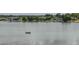 A scenic view of a lake with a fisherman enjoying a peaceful day on the water at 2219 Starboard Rd, Winter Haven, FL 33881