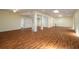 Spacious open-concept living room with wood flooring, ceiling fans, recessed lighting, and natural light at 2219 Starboard Rd, Winter Haven, FL 33881